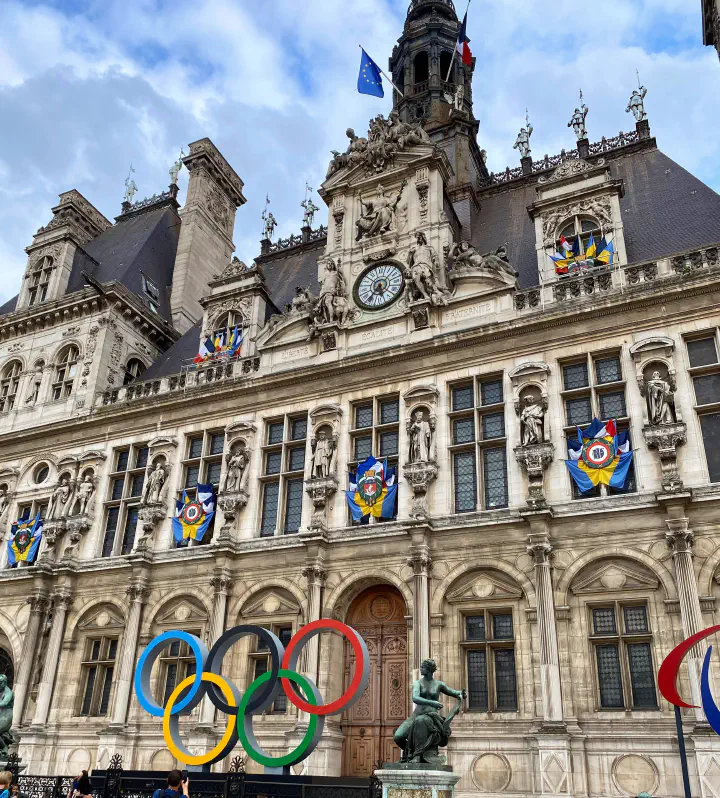A building in Paris with the Olympic Logo.
